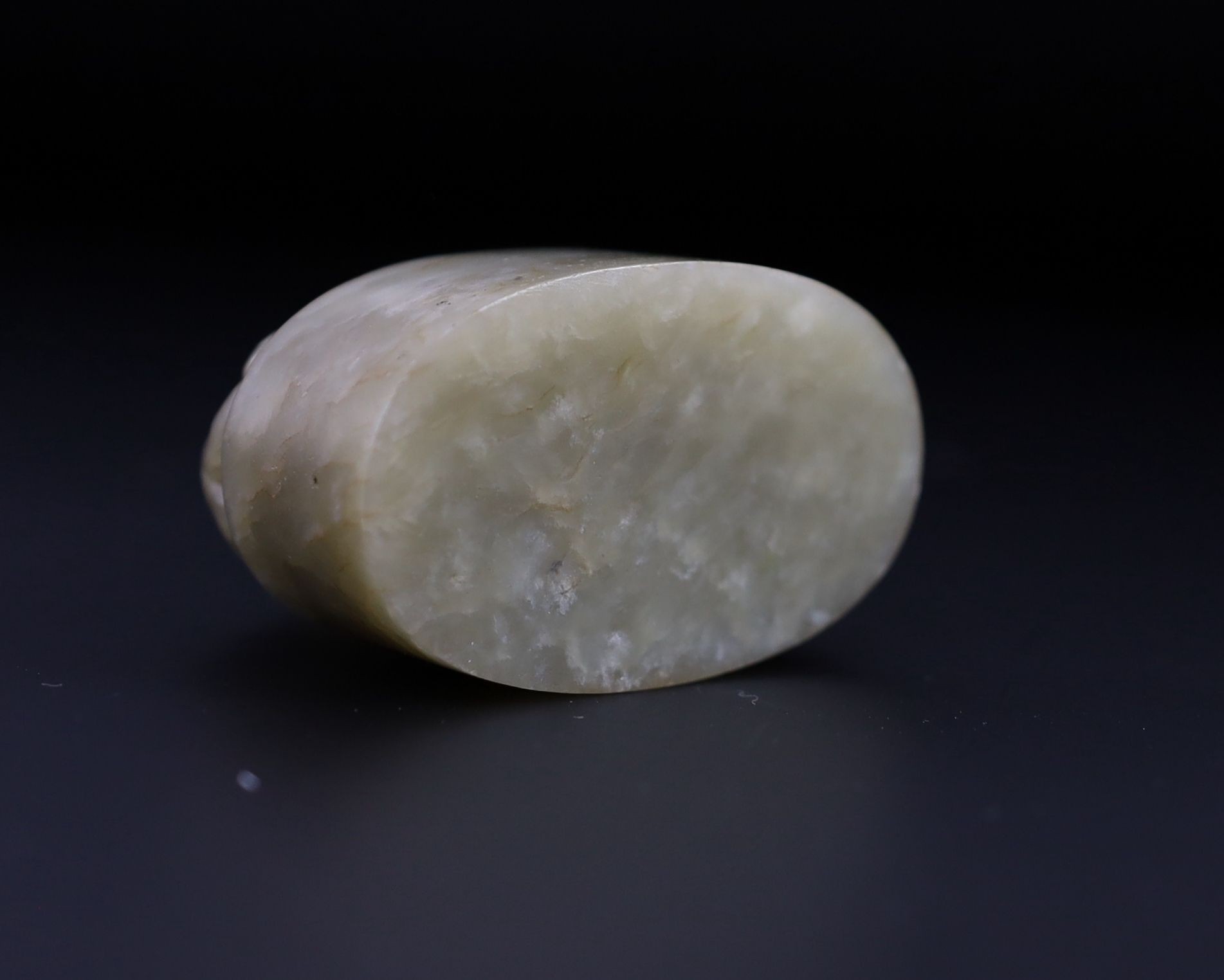 A Chinese celadon and white mottled jade ‘lion-dog’ seal, 18th/19th century, 6cm long